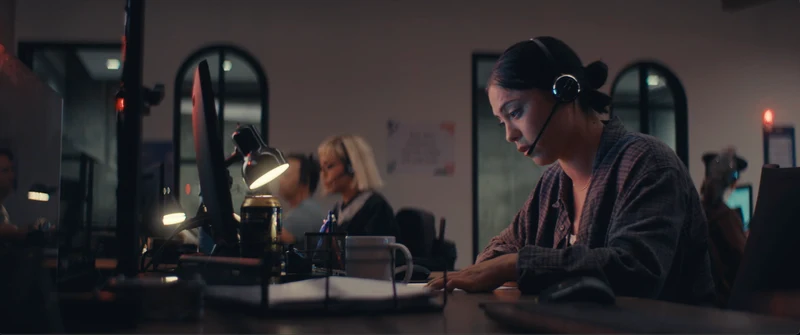 The crisis call center, lit by desk lamps.