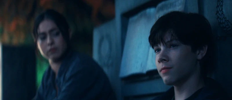 Rosa Salazar and Shylo Molina in profile, with colored lights behind them.