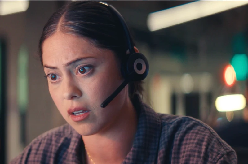 Rosa Salazar listening through a headset at the call center.