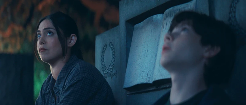 Rosa Salazar watches Shylo Molina lean back and look upward.