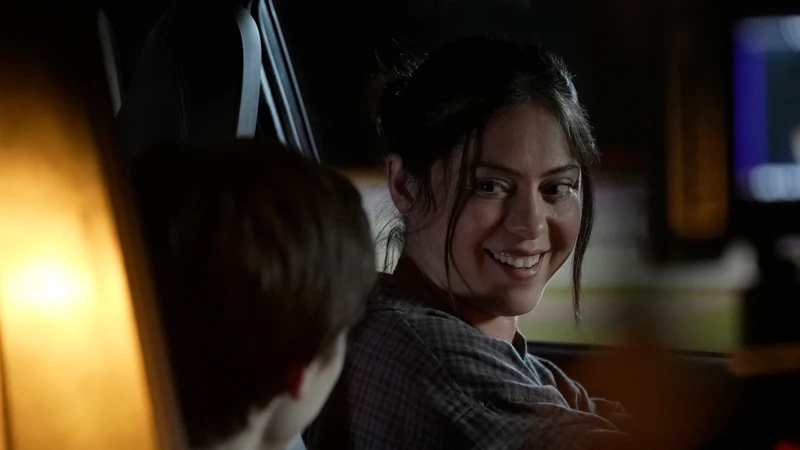 Rosa Salazar smiles back toward Shylo Molina inside a car.